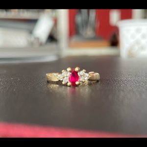 Beautiful ruby ring with 3 small diamonds on either side.